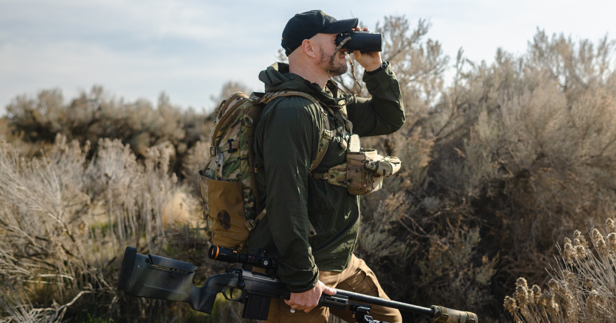 man carrying rifle with horus scope with tremor9